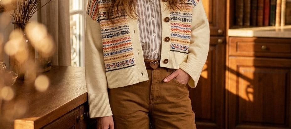 Minuit Douze Joely beige trousers worn with an ecru jacquard cardigan, hand in pocket